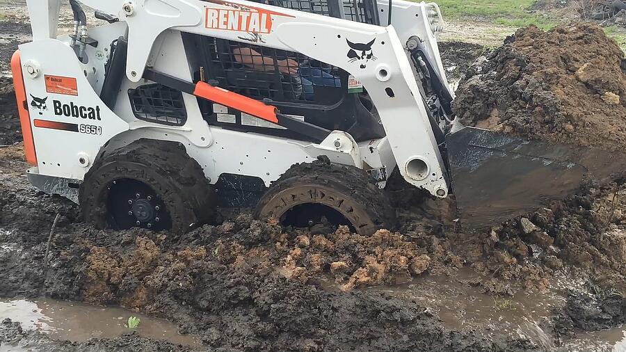 Skid Loader stuck in mud