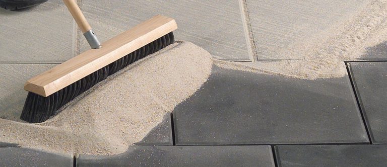 Sweeping sand into pavers